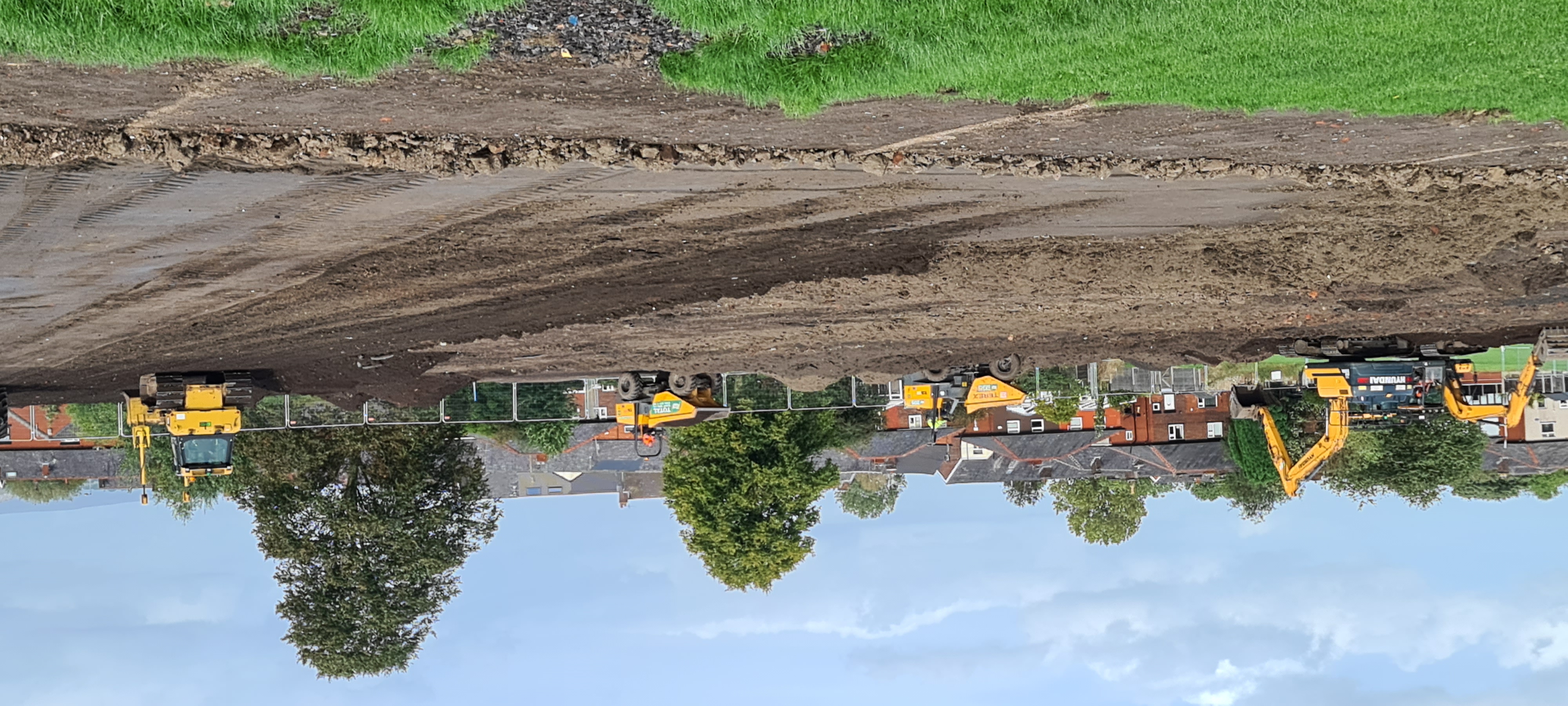 Bulldozers digging up a field