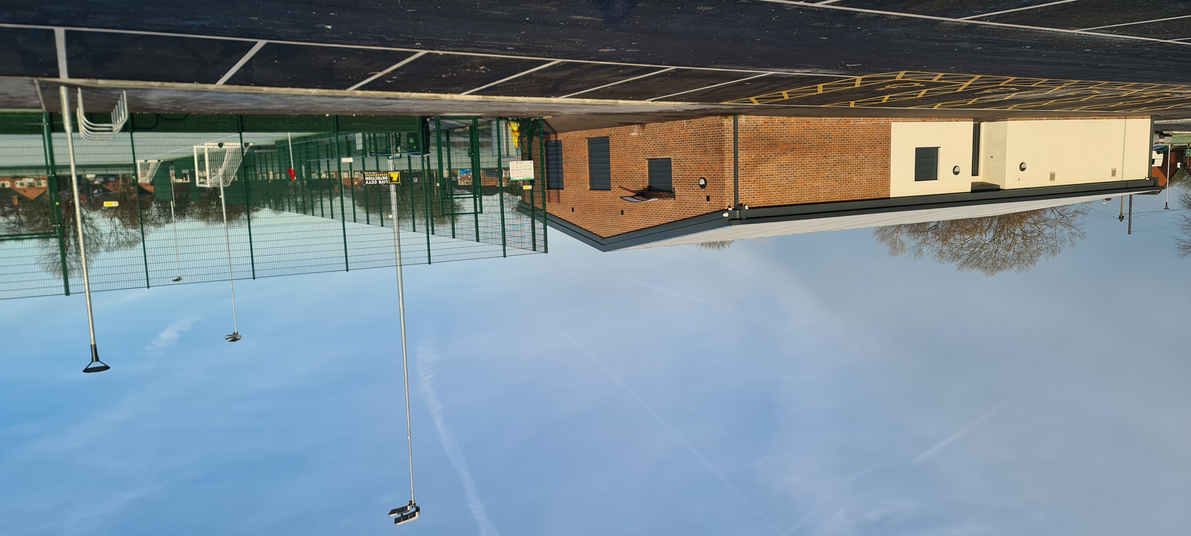 New single-storey building next to a football pitch and car park