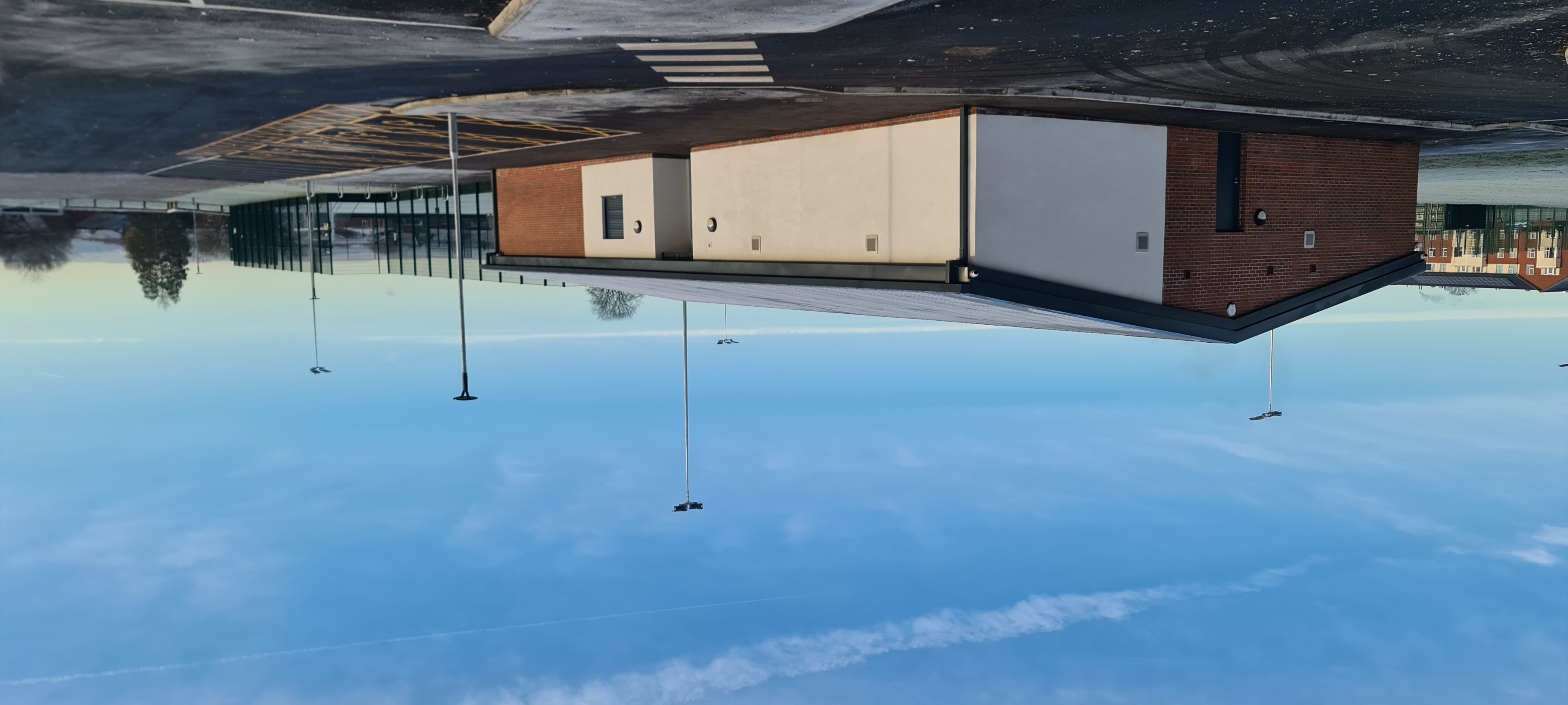 New single-storey building next to a football pitch and car park