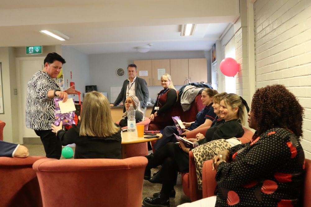 A group of people sitting talking.