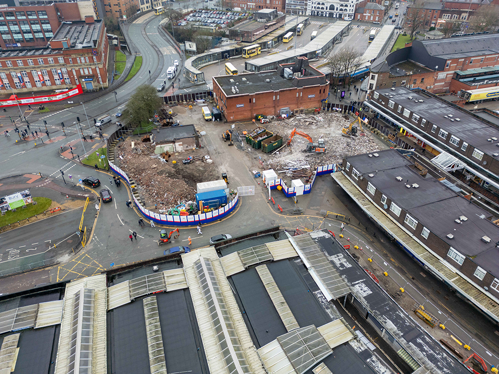 Aerial view of a construction site surrounded by buildings and roads 