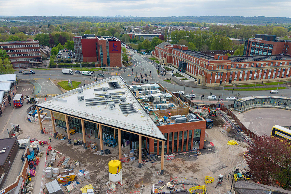 A large new two-storey building on a working building site