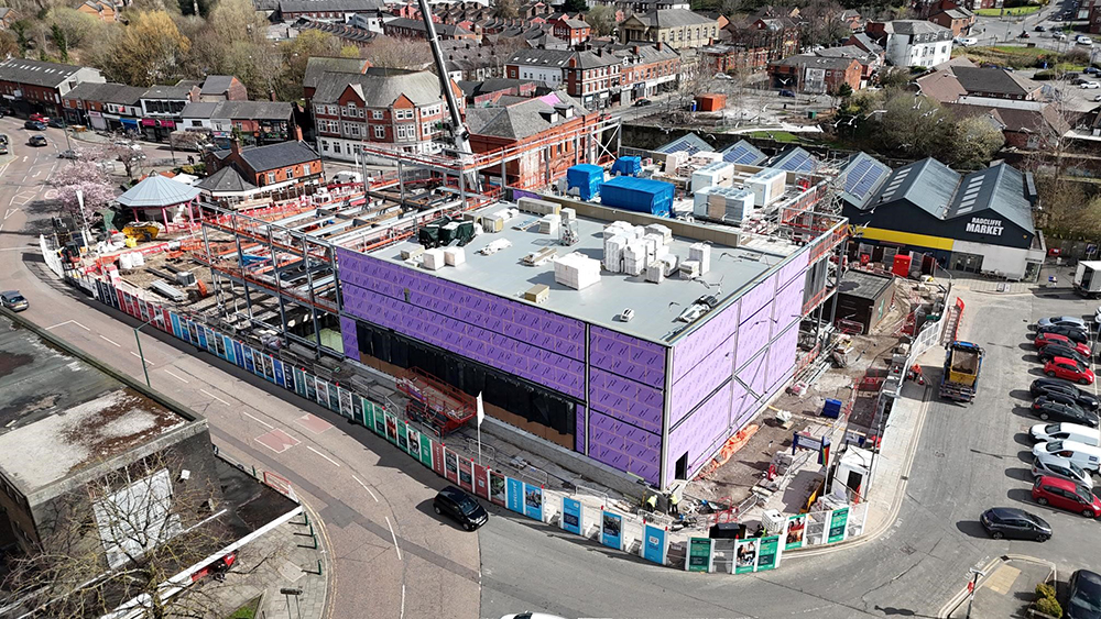 Aerial view of a construction site surrounded by a road