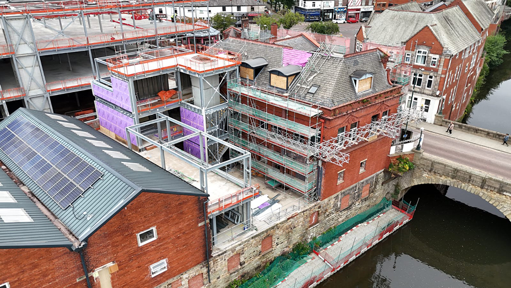 Steel framework joining two buildings
