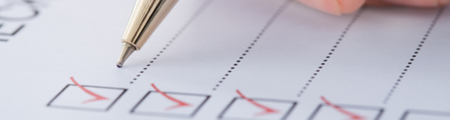 Small boxes on the left side ticked with a pen posed above the paper.