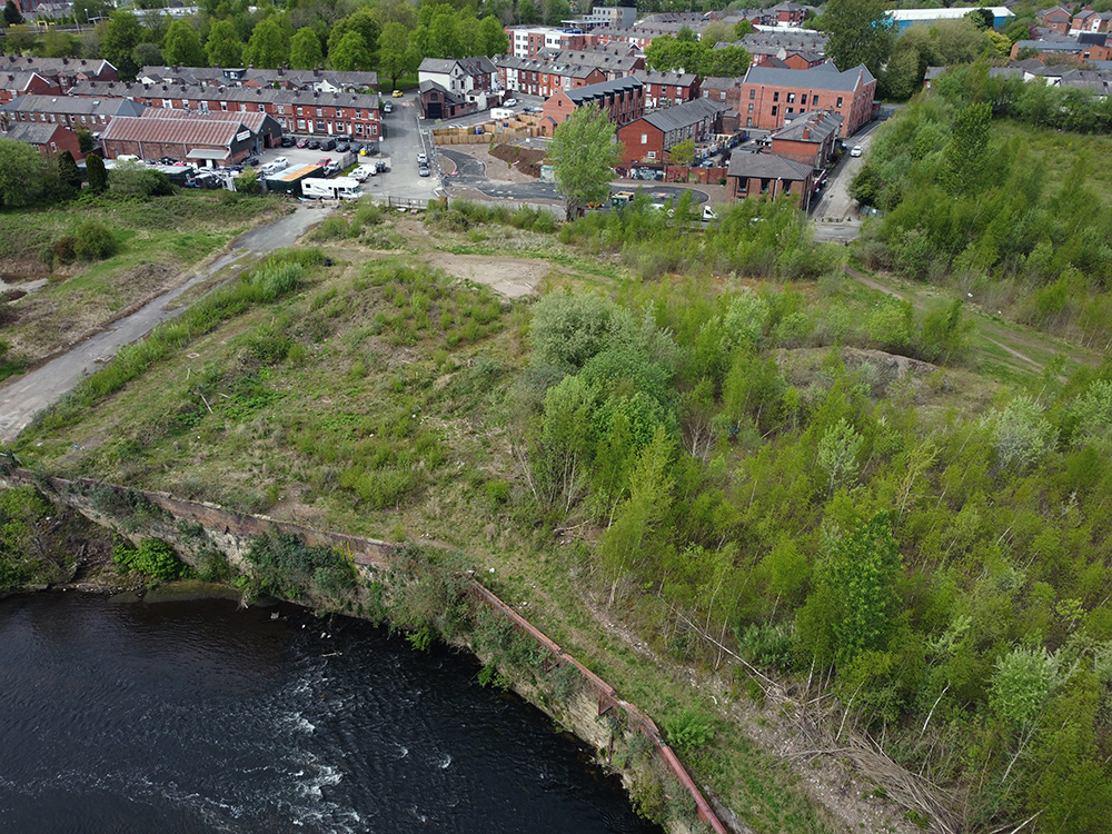 Buildings and greenspace alongside a river