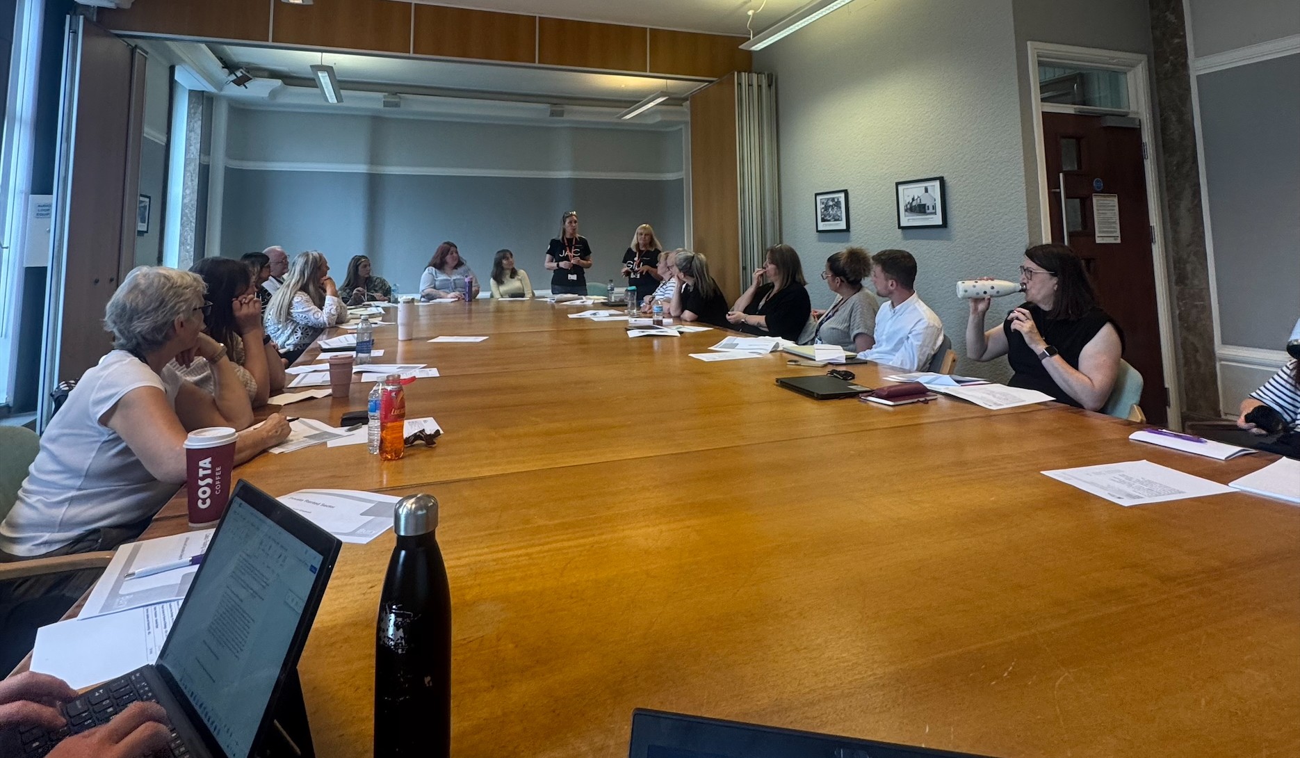 group of people sat around a large table