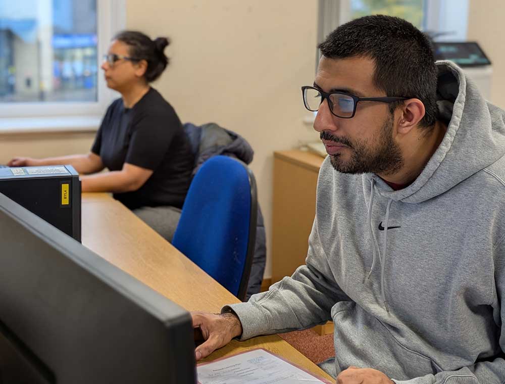 A person sat at a desk with a computer