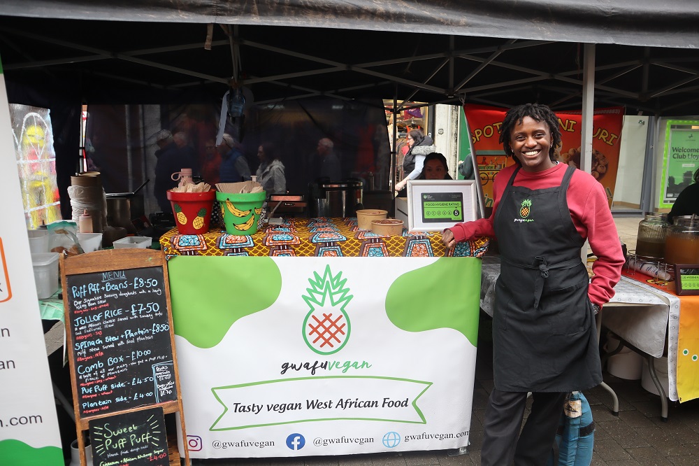 Person stood next to their food stall.