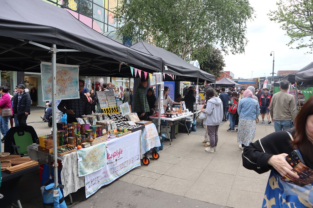 People looking at goods on stalls.