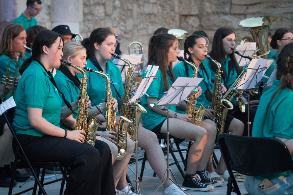   A group of people playing brass instruments.