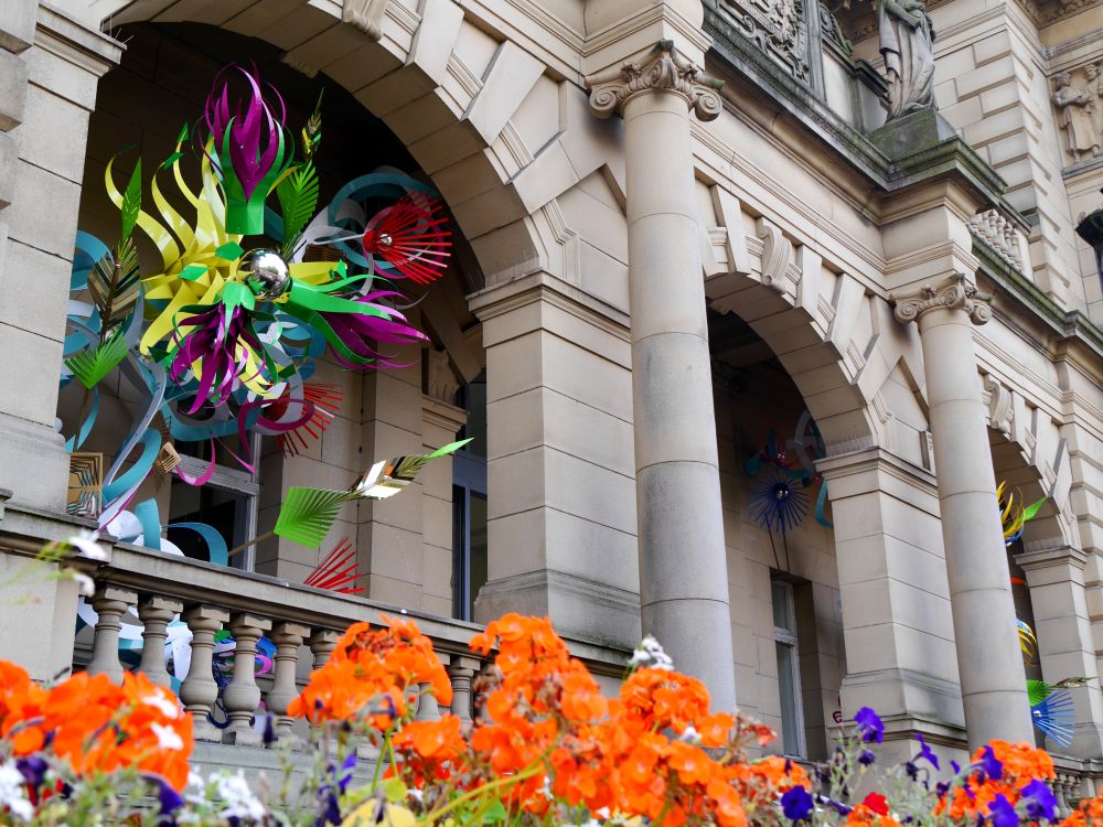 A stone building decorated with sculptures and flowers.