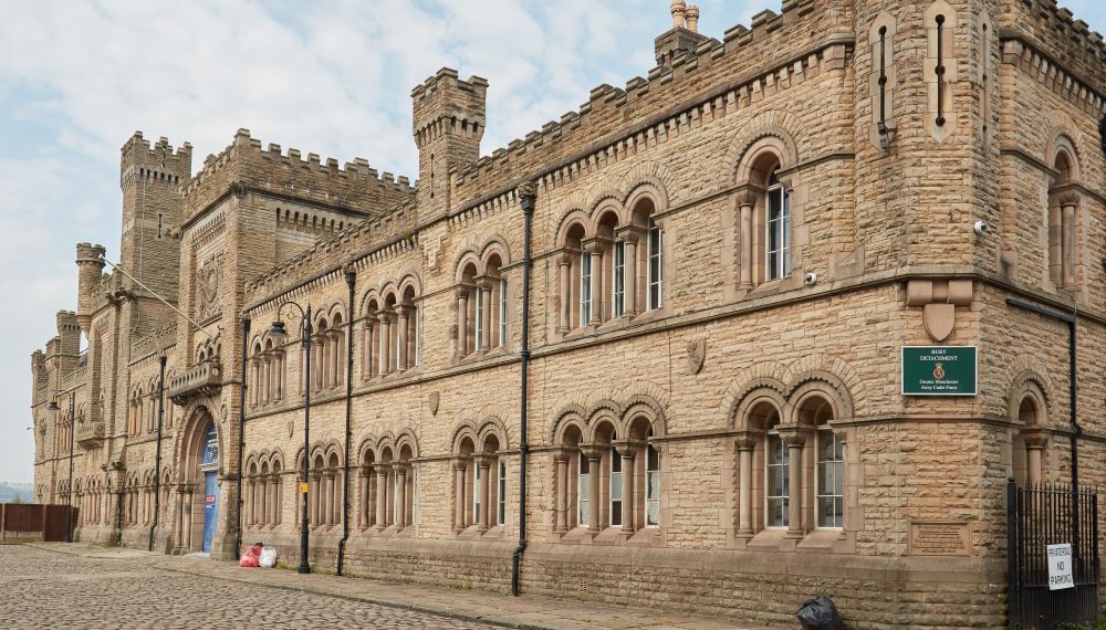 Large stone clad castle style building.