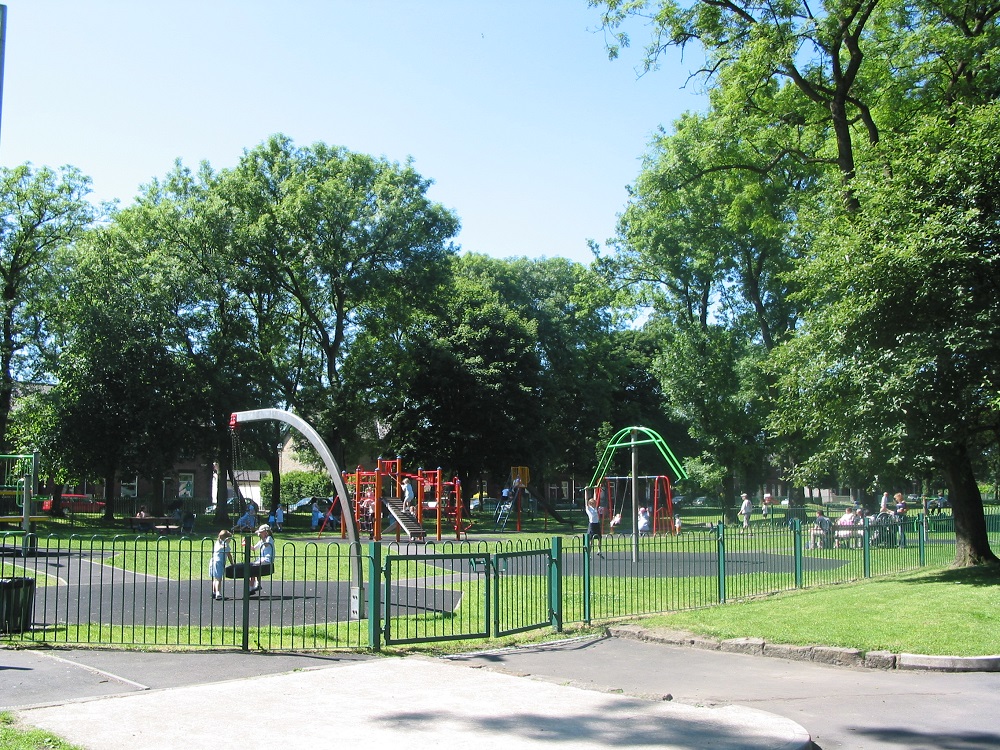 Gated play area with swings.