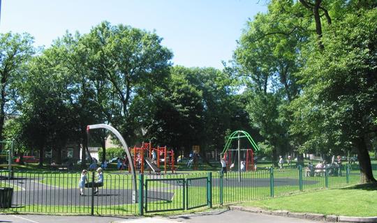 Gated play area with swings.
