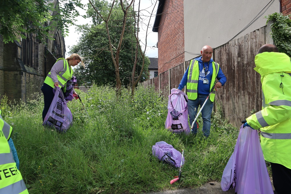 People clearing a patch of land