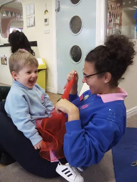 adult playing with a child