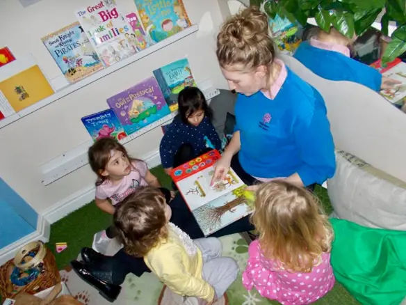 adult reading to a group of children