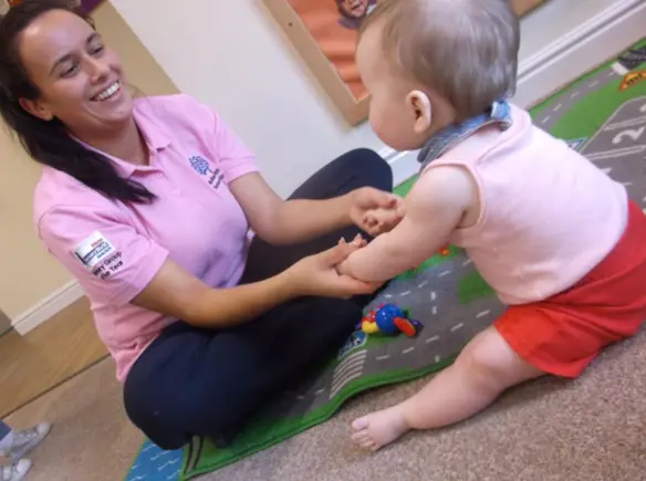Early years worker interacting with a child