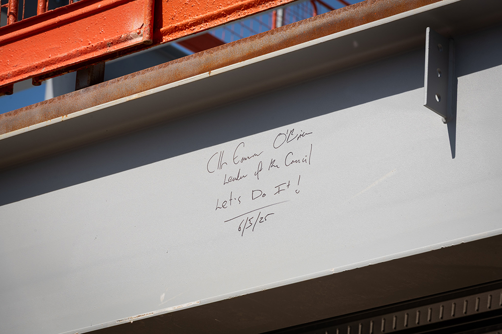 A handwritten message on a beam that reads, Cllr Eamonn O'Brien, Leader of the Council, Let's Do It, 6/5/25