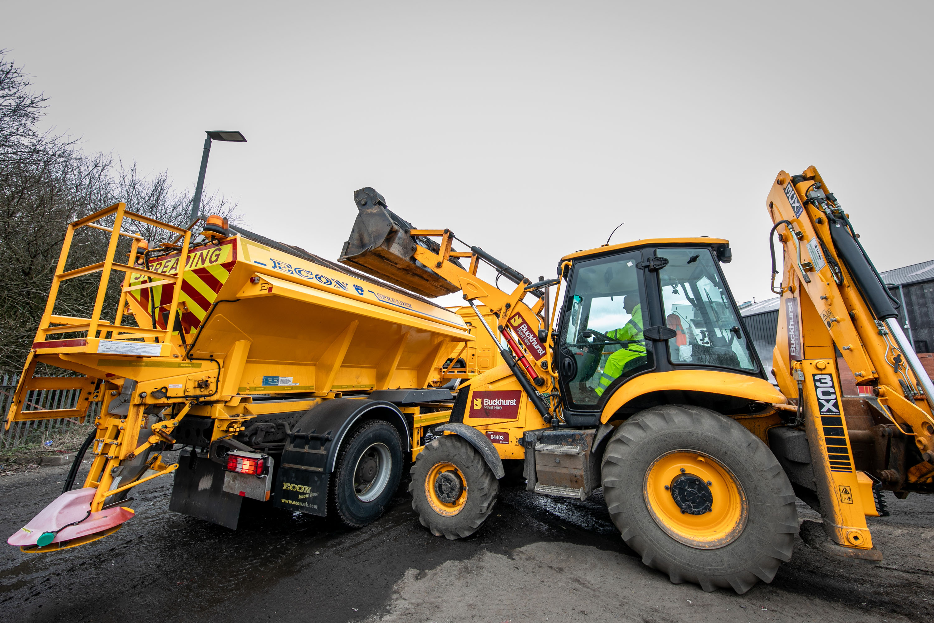 Two large yellow vehicles