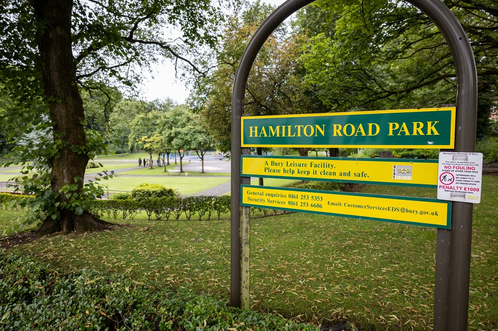Park sign surrounded by trees.