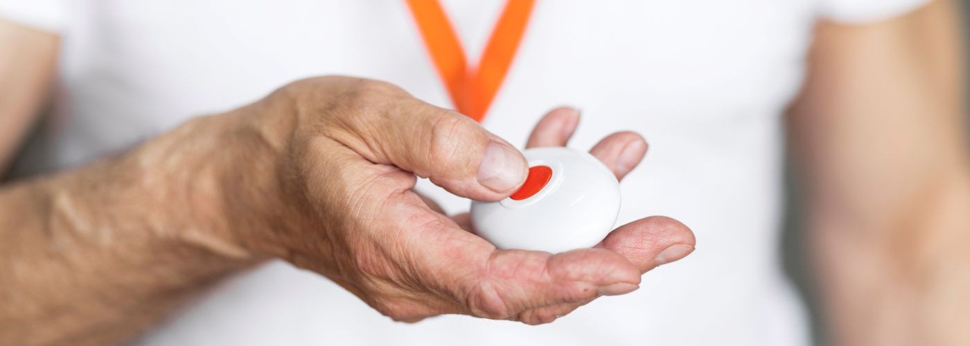 hand holding a carelink alarm