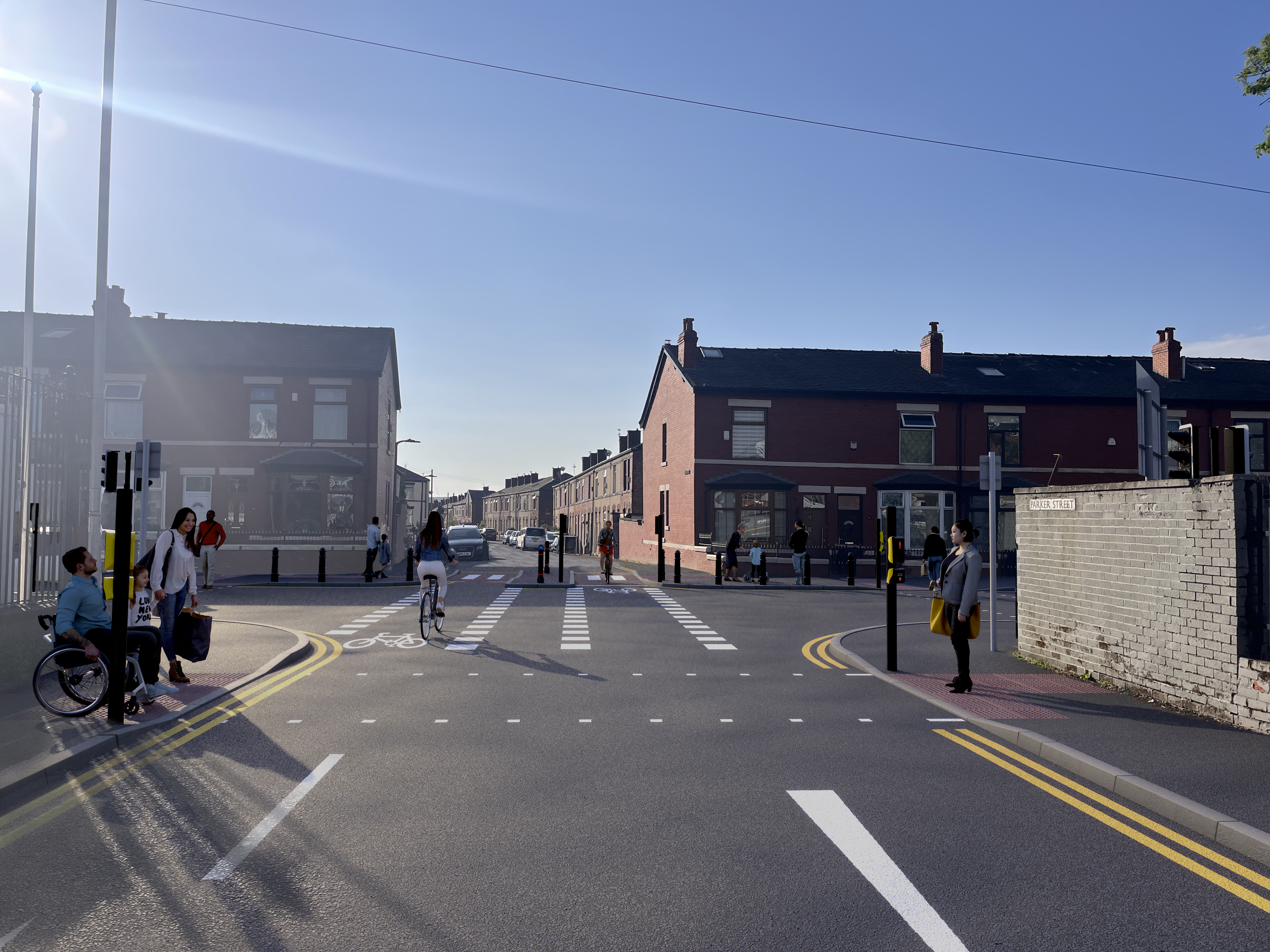 A crossroads in an urban street. People are walking and cycling
