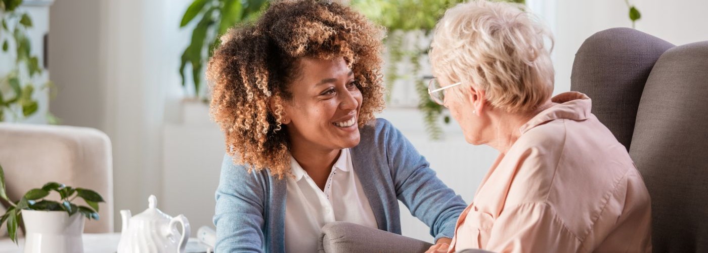 A care worker talking to an adult