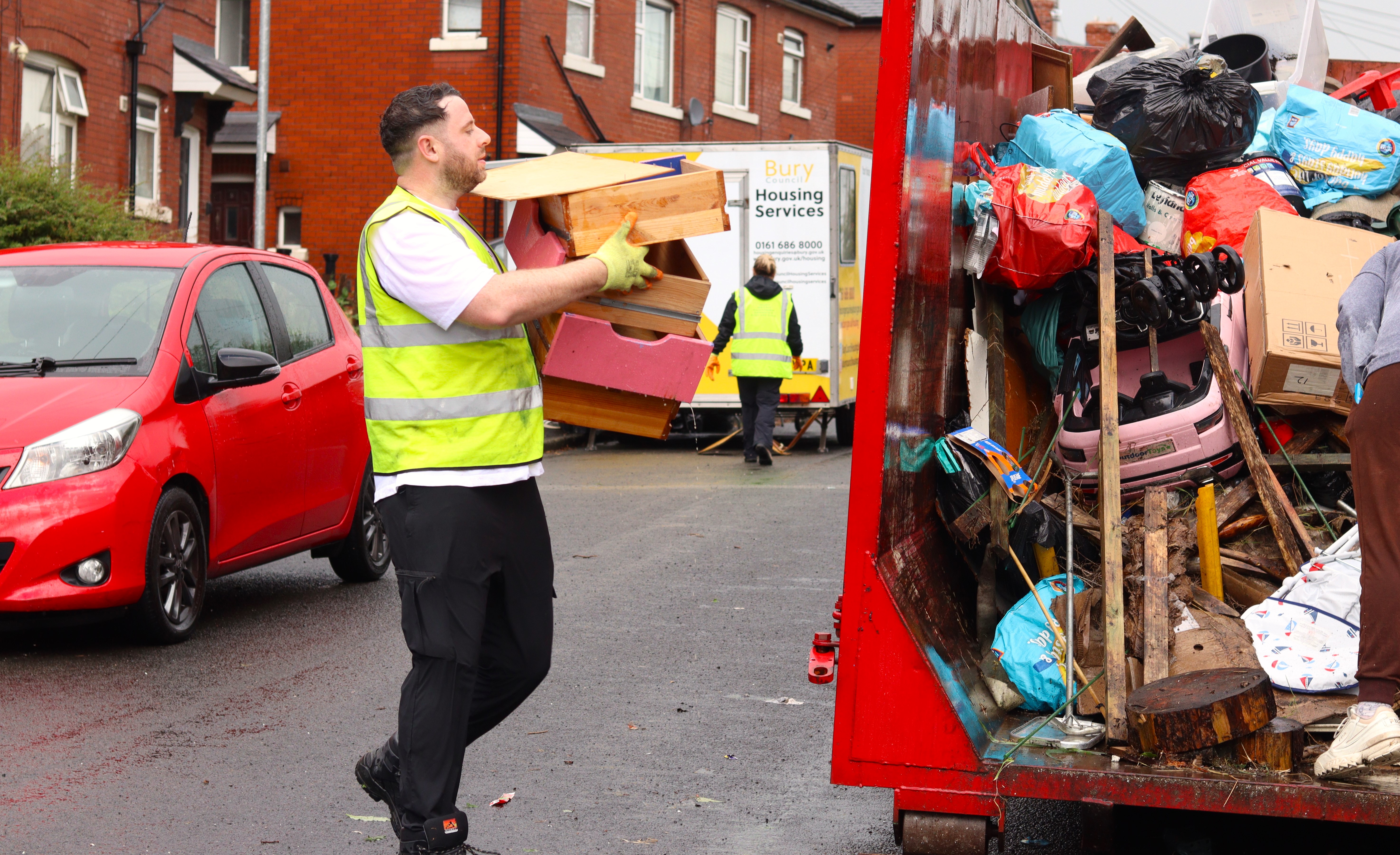volunteer helping load skip 