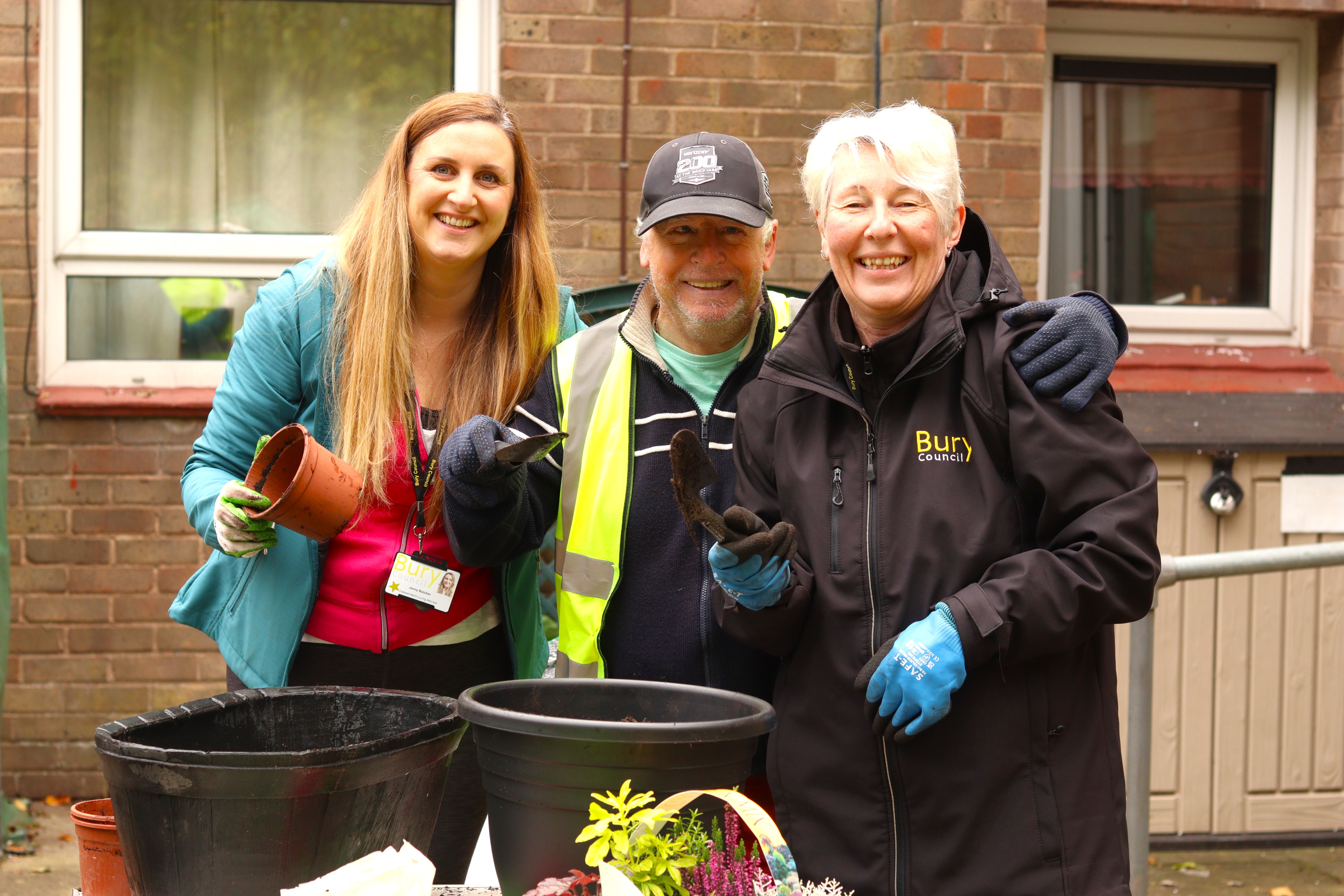 Staff and tenant volunteers gardening 