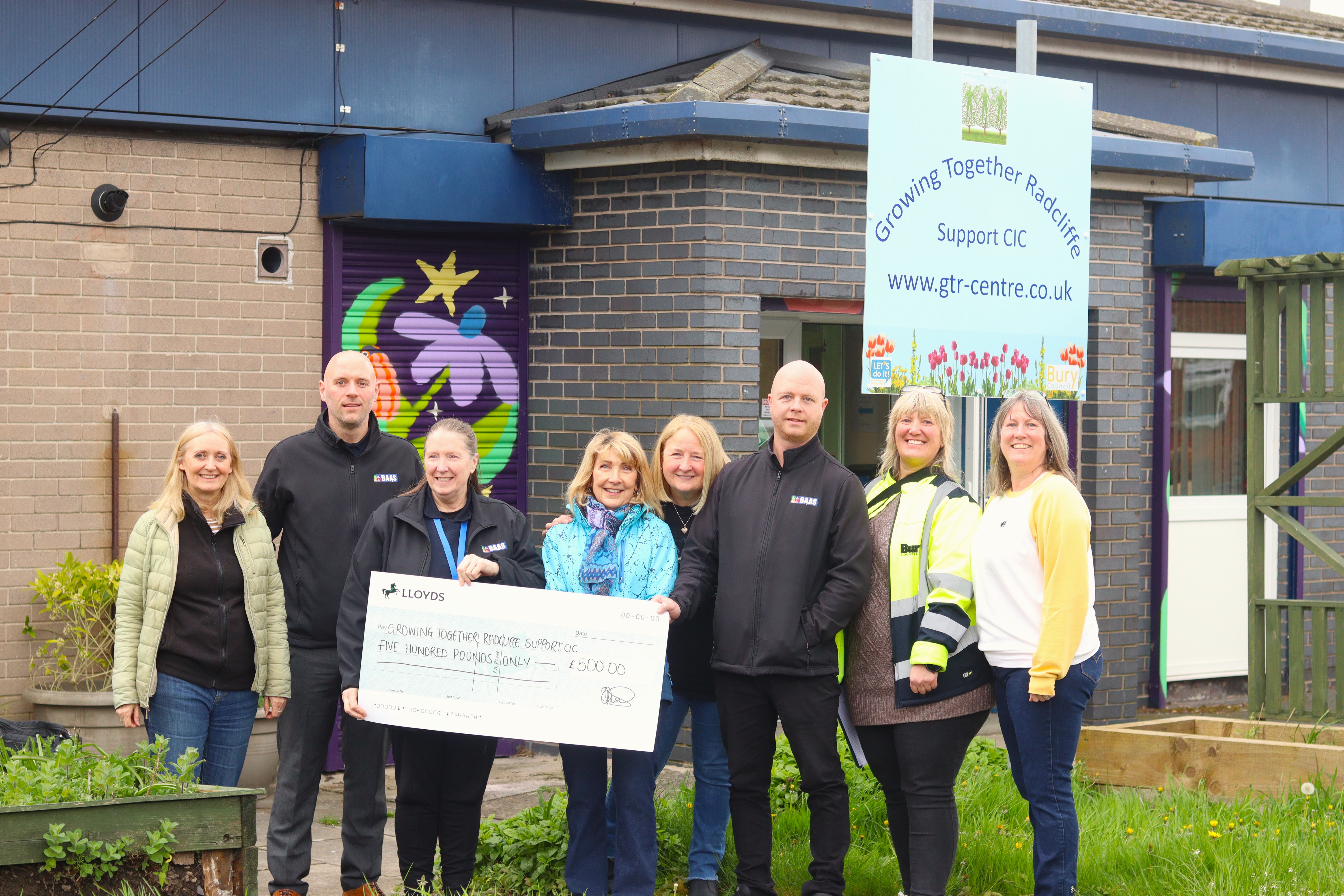 BAAS Staff present Growing Together Radcliffe volunteers with the £500 cheque, joined by Housing Services.