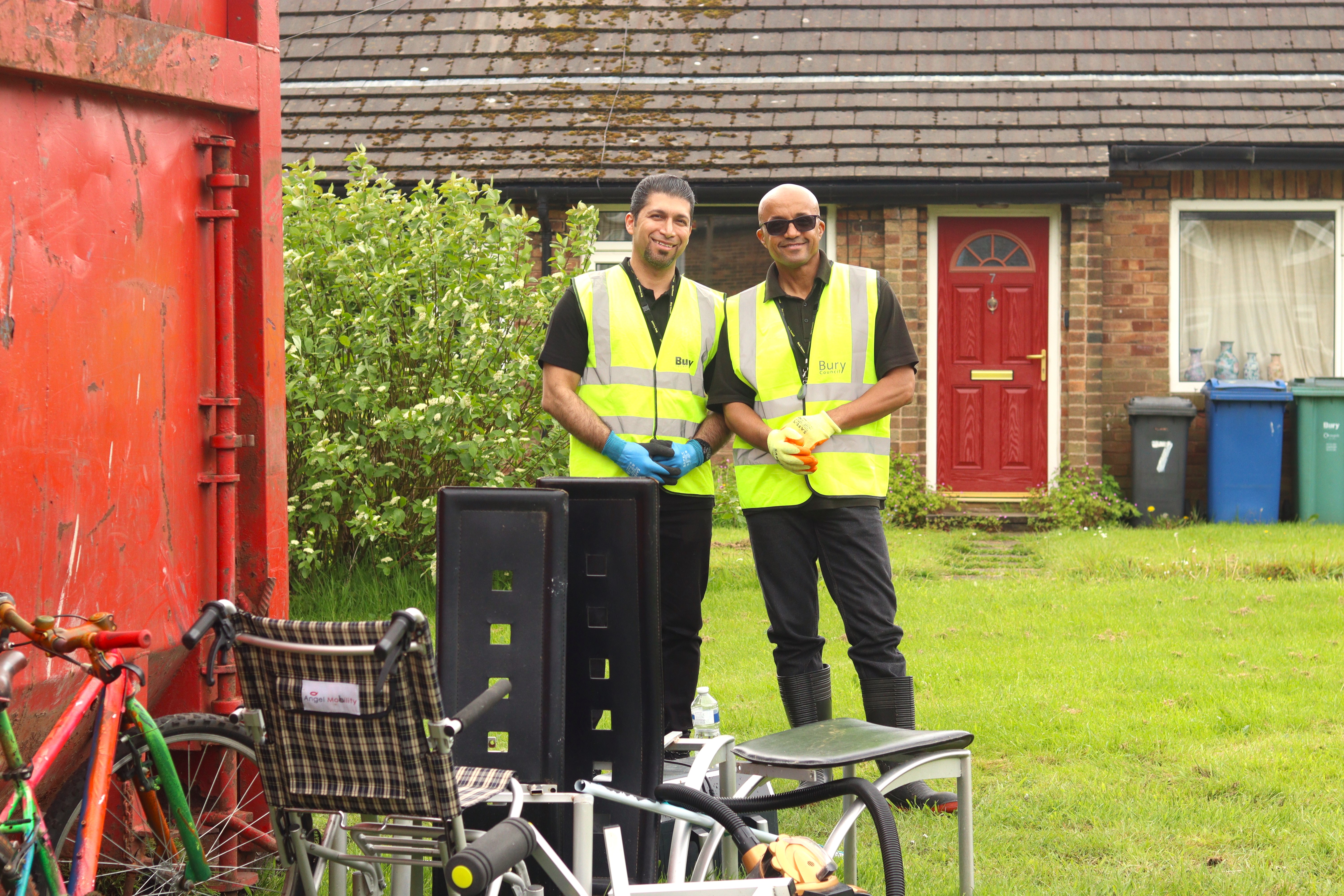 staff smiling next to skip 