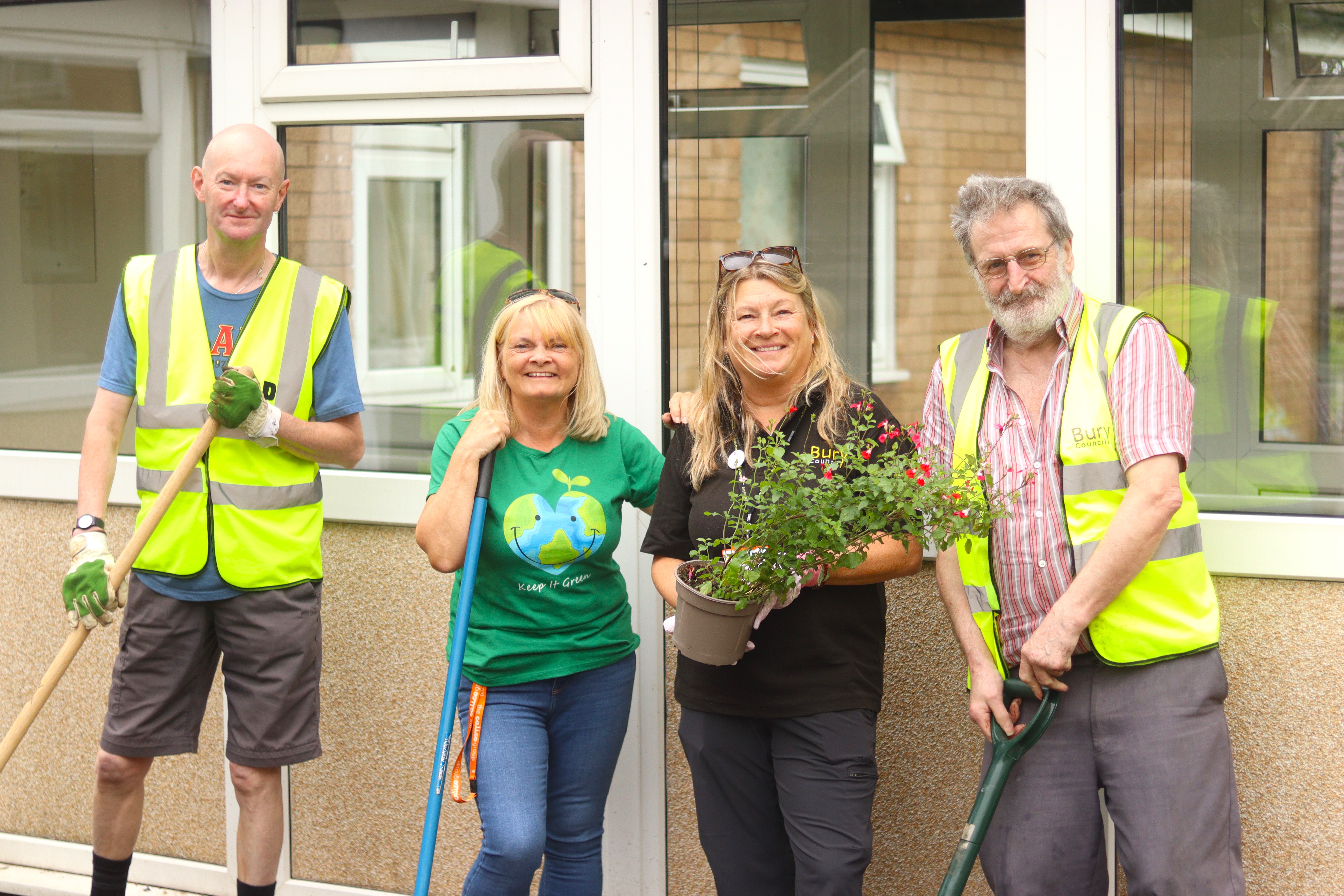 Staff and volunteers in hardwood house garden
