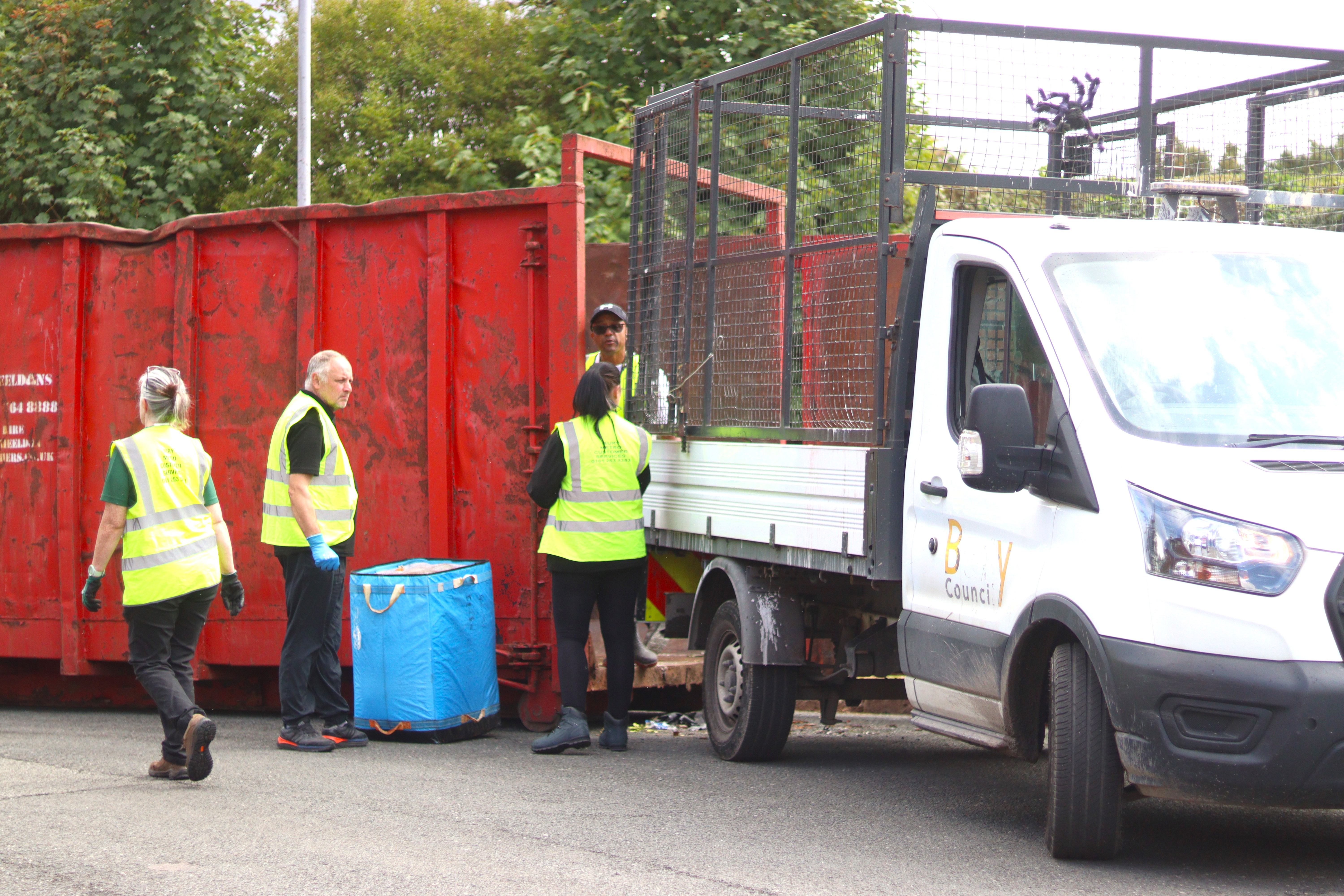 staff filling the skip