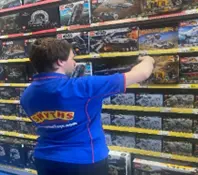 Picture of man putting things on a shelf