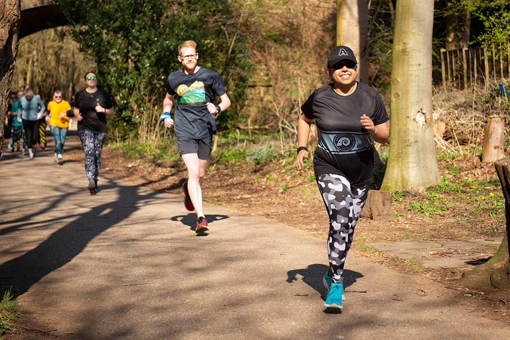 Group of runners on a countryside lane surrounded by trees