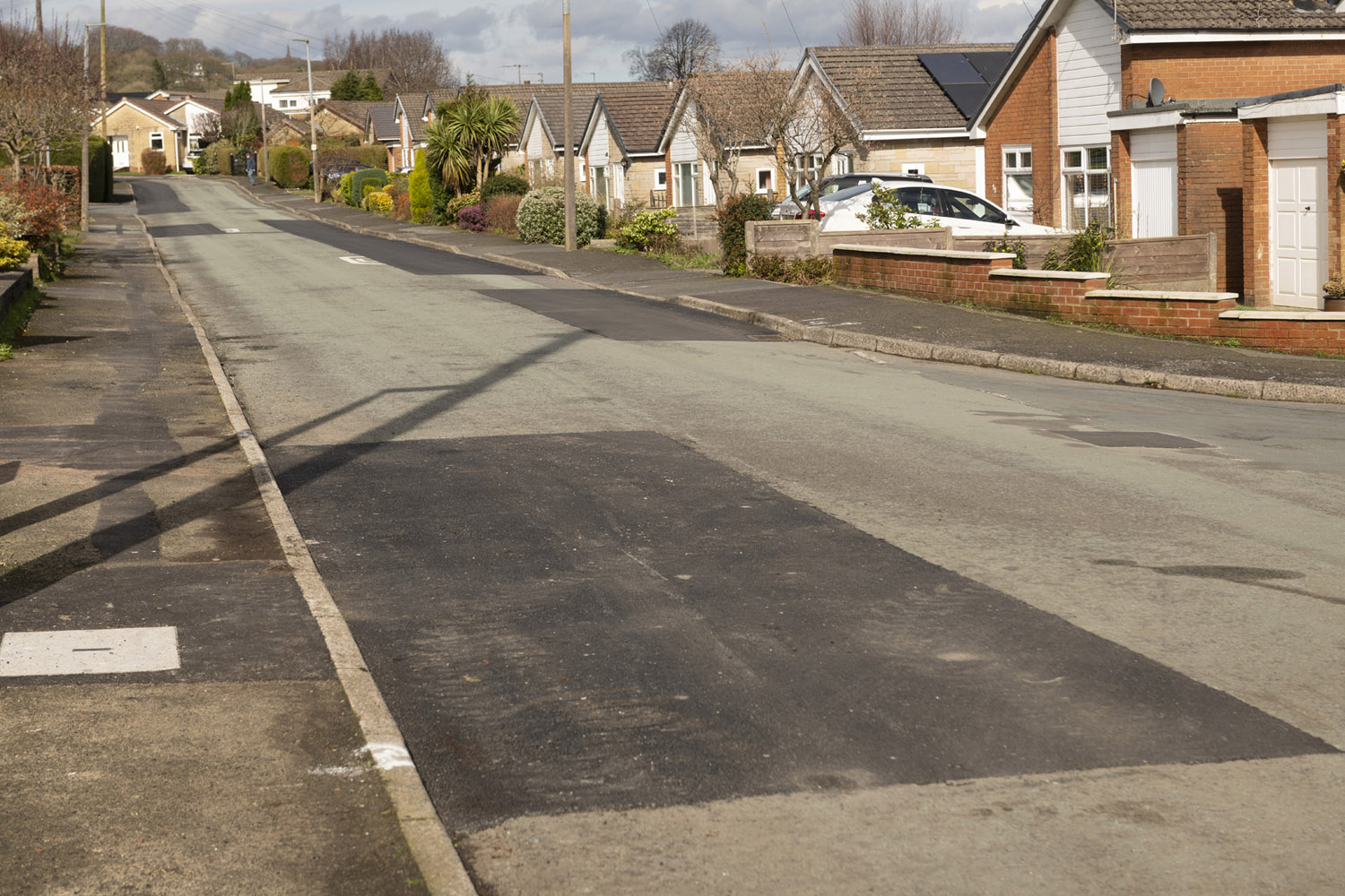 A road with new patch of tarmac