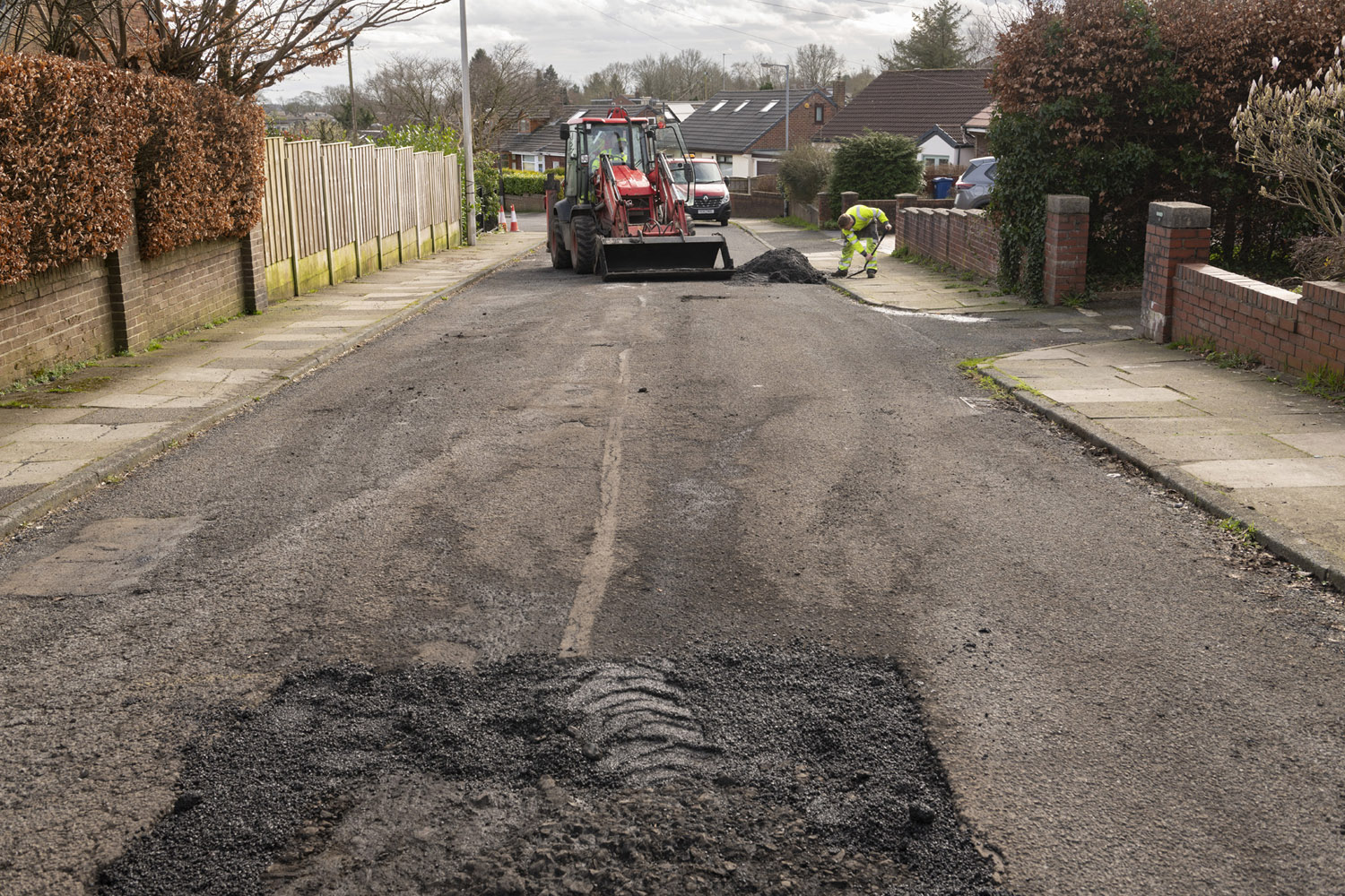 A road that has a patch of the surface removed