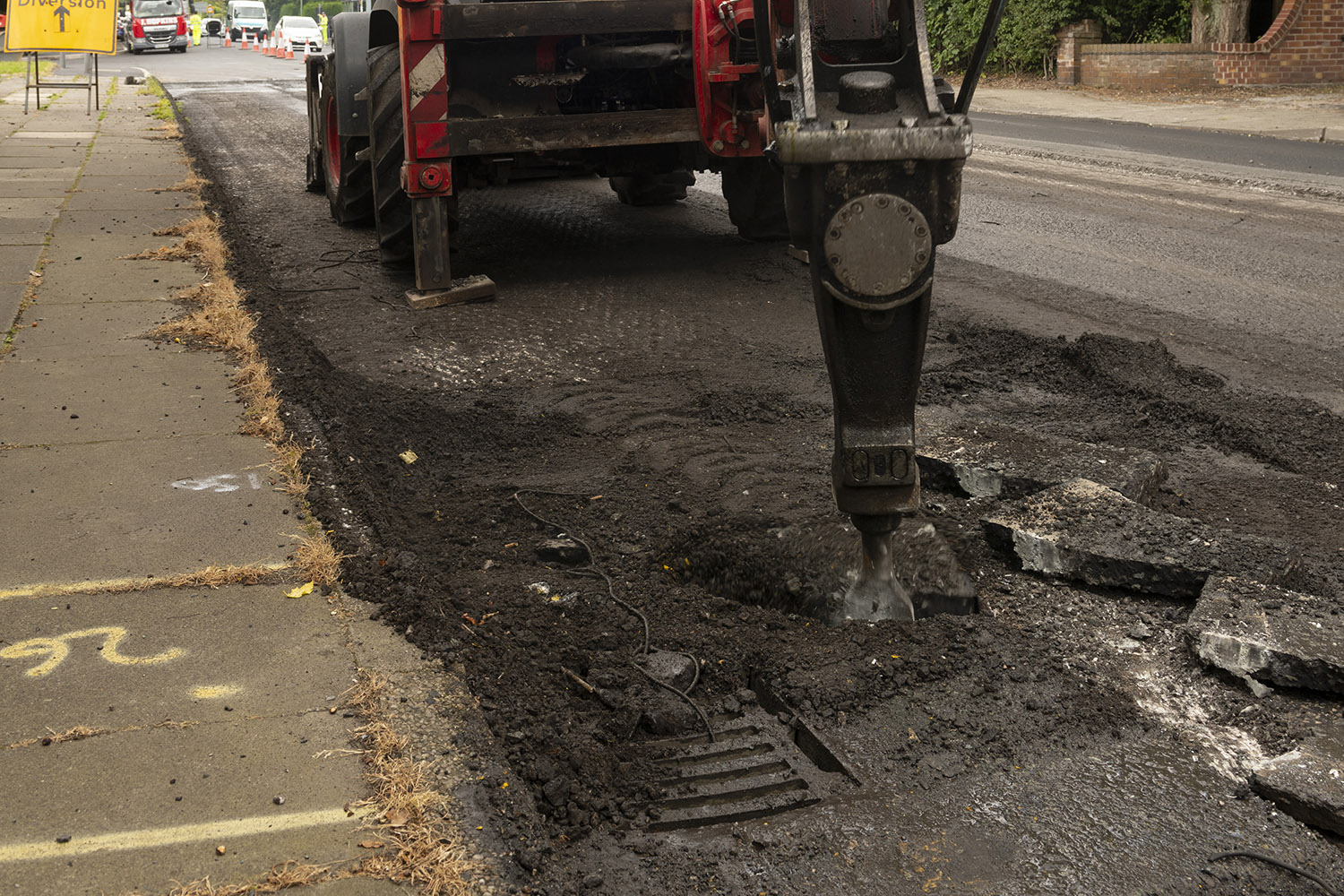 Large machine digging into a road