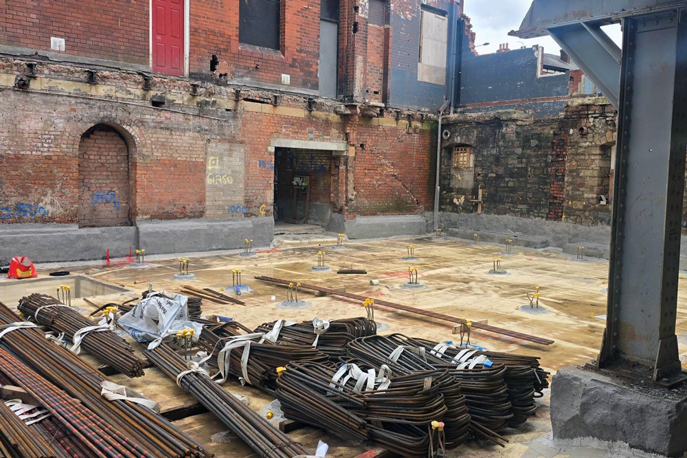 Piles of steel rods on the ground of a building site