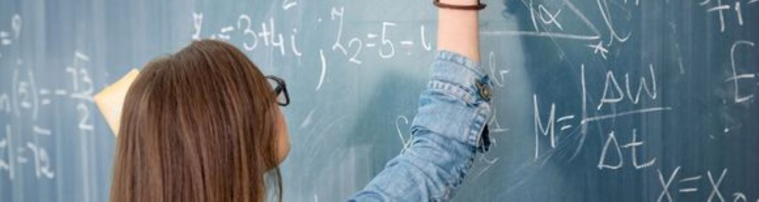 a young person doing maths on a chalkboard