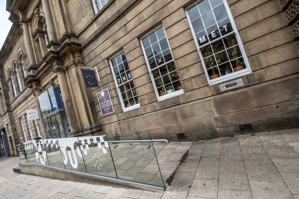 Ramp leading up to the entrance of a stone building.