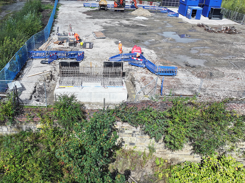 A building site on top of a steep bank down to a river
