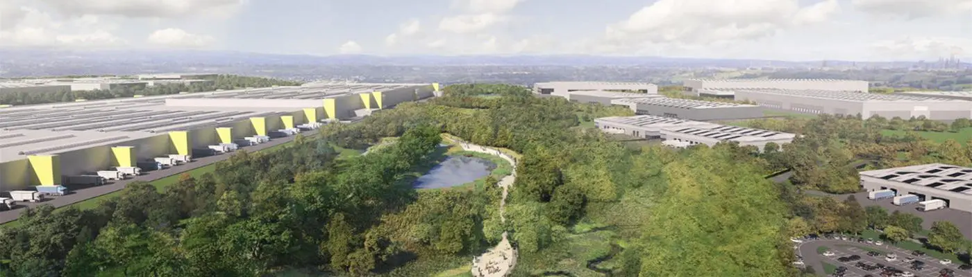 Aerial view showing commercial buildings and trees and green areas
