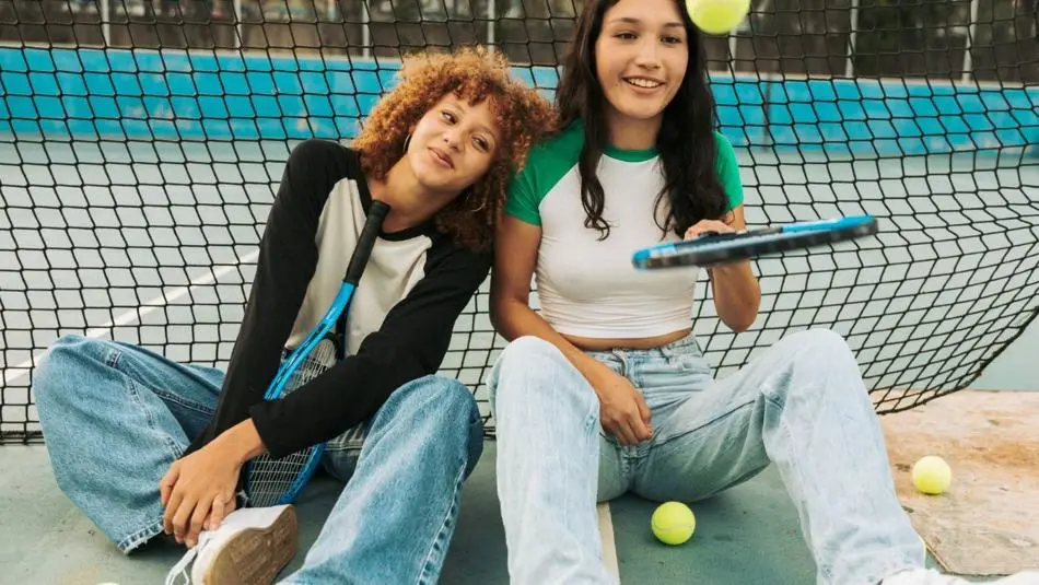 Photo of two girls on a tennis court