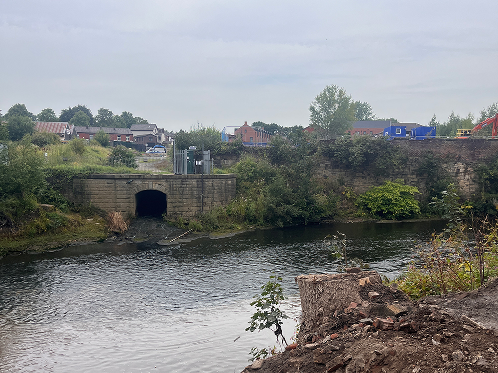A river and pier surrounded by houses