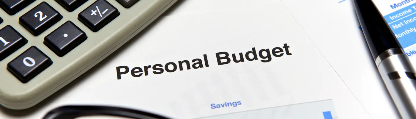 personal budget written on a page and a calculator
