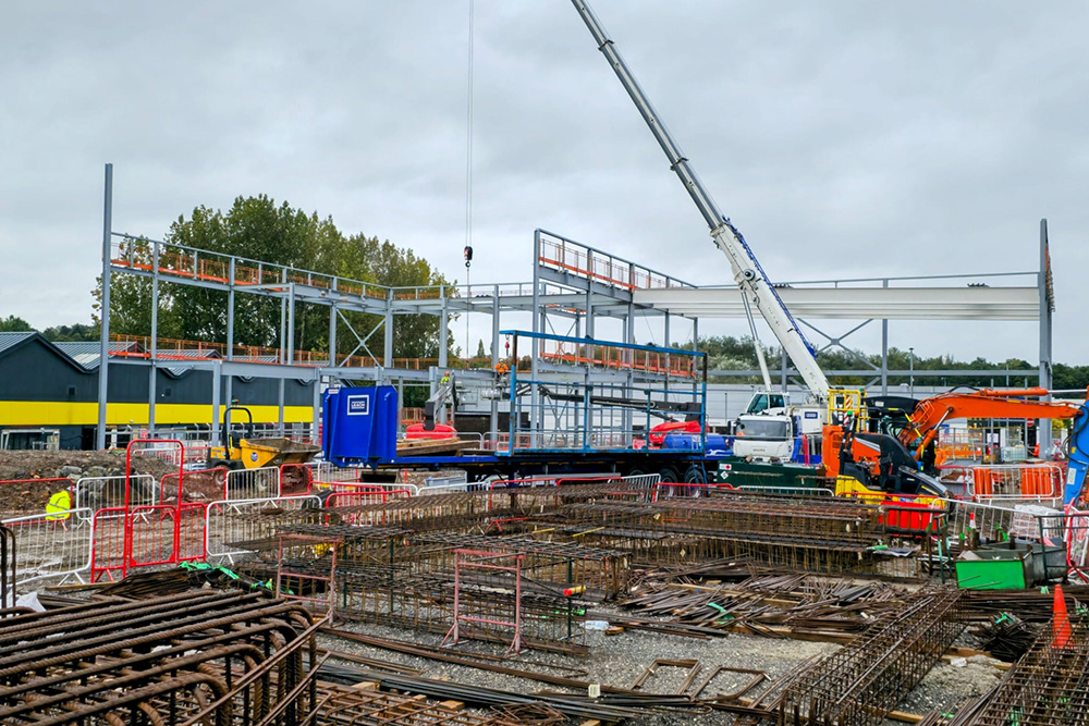 Steel building frame and a crane on a construction site