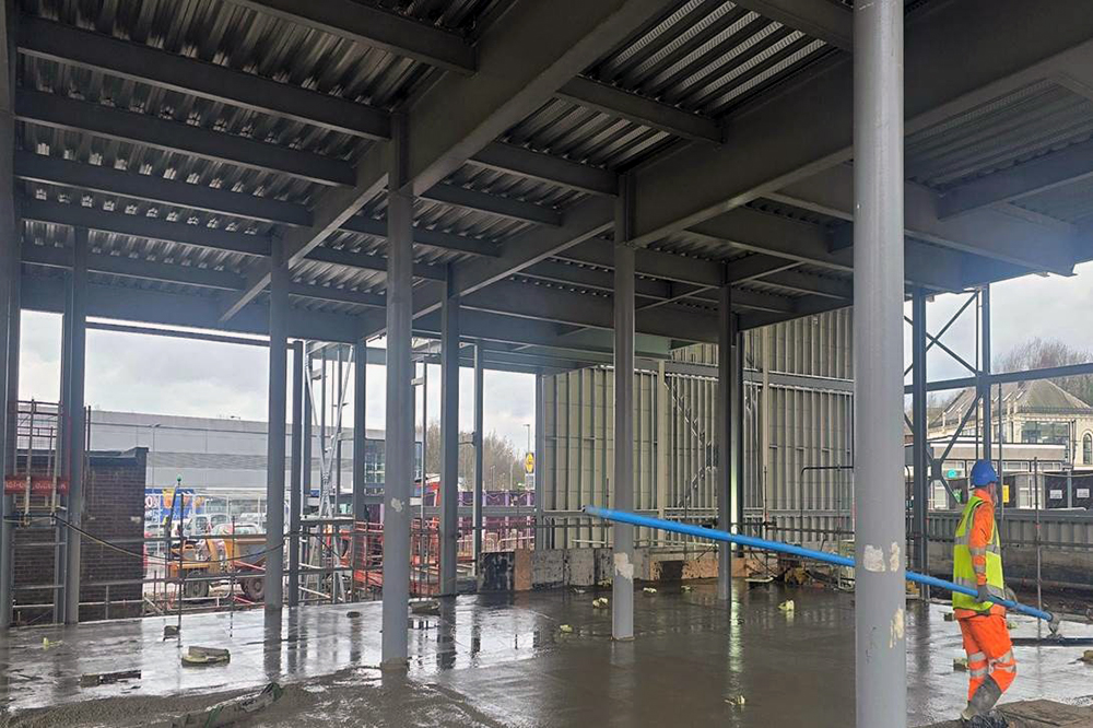 Steel building frame with a concrete floor on a building site